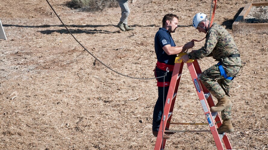 Marine Corps Sgt. Maj. Bryan B. Battaglia, Senior Enlisted Advisor to the Chairman of the Joint Chiefs of Staff, prepares to swing from the giant swing at the Holloman ropes course, Holloman Air Force Base, N.M. March 6. The purpose of the ropes course is to teach Airmen to recognize stress responses and engage with those responses constructively to enable critical thinking under stress. (U.S. Air Force photo by Airman 1st Class Emily A. Kenney/Released)