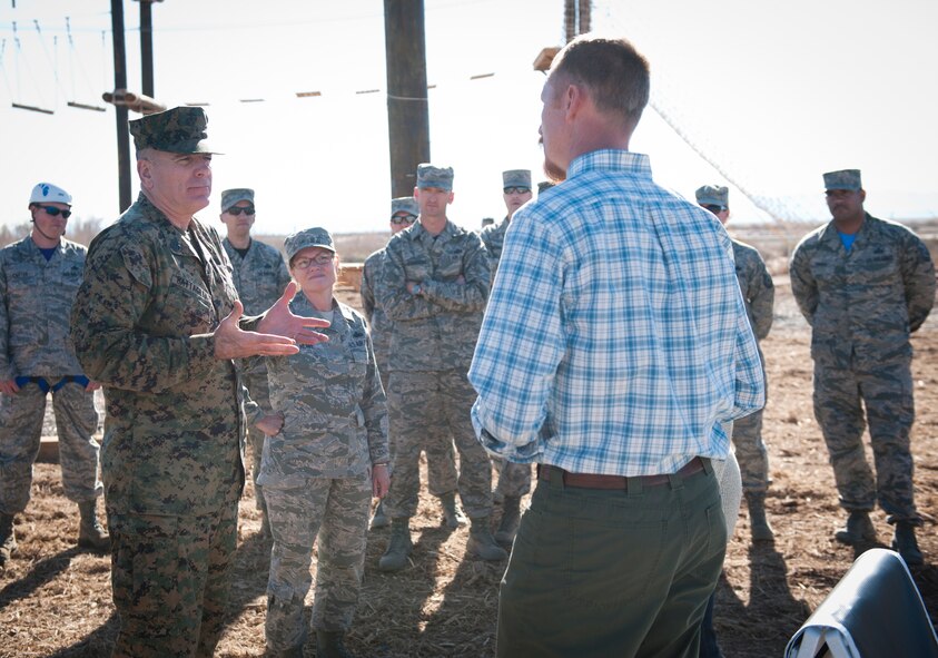Marine Corps Sgt. Maj. Bryan B. Battaglia, Senior Enlisted Advisor to the Chairman of the Joint Chiefs of Staff, talks with Ted Brinegar, 49th Wing community support coordinator, at the Holloman ropes course, Holloman Air Force Base, N.M. March 6. During Battaglia’s visit to Holloman, he learned about how Airmen use the ropes course as a tool to engage constructively with stress. Prior to speaking at the 2015 Chief Master Sgt. Induction ceremony, Battaglia visited with Airmen and received Holloman mission briefings.  (U.S. Air Force photo by Airman 1st Class Emily A. Kenney/Released)