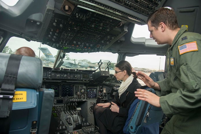 Captain Rob Hannah, 16th Airlift Squadron C-17 pilot, explains C-17 cockpit instruments to Cori Lovern, Honorary Commander, at Joint Base Charleston, S.C., March 6, 2015. The JB Charleston Honorary Commanders Program encourages an exchange of ideas, experiences, and friendship between key members of the local civilian community and the Charleston military community. The program provides a unique opportunity for the members of the Charleston area to shadow commanders of the Air Force wings and groups, as well as Navy and tenant units at JB Charleston. (U.S. Air Force photo/Senior Airman George Goslin)