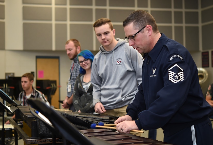 Master Sgt. Tom Rarick, U.S. Air Force Band Ceremonial Brass percussionist, demonstrates an instrument technique on the xylophone to students at McClintock High School in Tempe, Ariz., Jan. 27, 2015. In between country-wide performances, Band members hold Advanced Innovation through Music clinics to advise, mentor and educate students on music. (U.S. Air Force photo/ Senior Airman Nesha Humes)