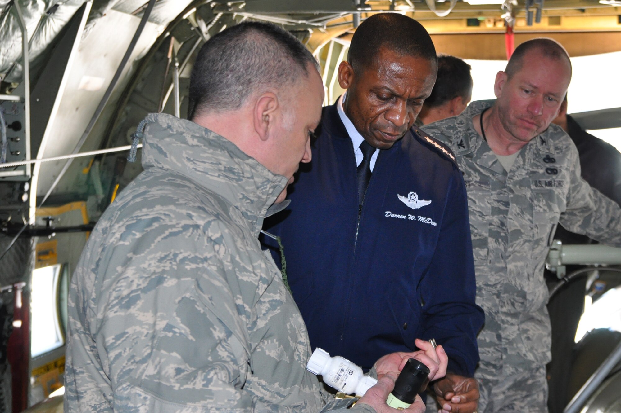 YOUNGSTOWN AIR RESERVE STATION, Ohio – Air Force Reserve Senior Master Sgt. Phil Aliberti, 910th Airlift Wing aerial spray maintenance chief, shows an aerial spray nozzle to Air Mobility Command Commander Gen. Darren W. McDew, while 910th Maintenance Group Commander Col. David Post watches aboard a modified C-130H Hercules aircraft here, March 9, 2015. McDew, a four star general, visited here to meet with wing leadership, tour the installation and get an up close look at the 910th’s mission and capabilities. The 910th airlift Wing is home to the Department of Defense’s only large-area fixed-wing aerial spray capability. U.S. Air Force photo by Master Sgt. Bob Barko Jr.