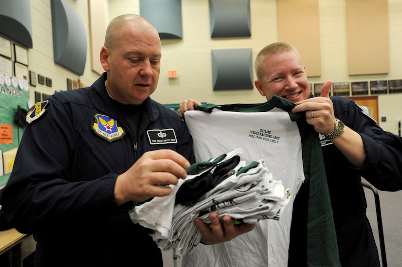 Tech Sgt. Robert K. Smith, U.S. Air Force Band Max Impact percussionist and Jonathan McPherson, USAF Band Max Impact pianist, looks at T-shirts at Skyline High School in Mesa, Ariz., Jan 30, 2015. The high school music class gave the rock stars Skyline band shirts to thank them for their Advancing Innovation through Music workshop. (U.S. Air Force photo/ Senior Airman Nesha Humes)
