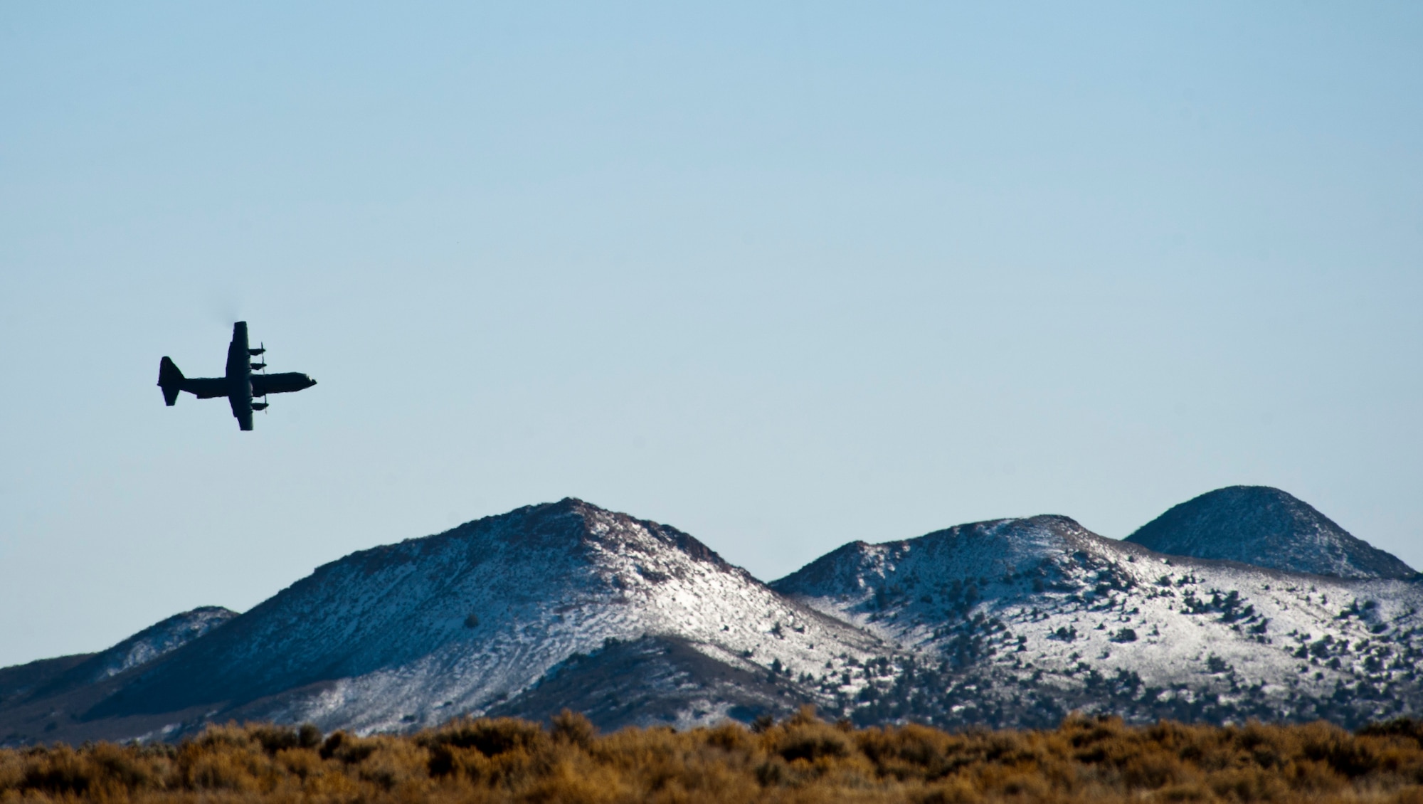 A Royal Norwegian air force C-130J Super Hercules flies during a training exercise during Red Flag 15-2 over the Nevada Test and Training Range, March 6, 2015. Since 1975, 28 countries have participated in Red Flag exercise. (U.S. Air Force photo by Senior Airman Thomas Spangler)
