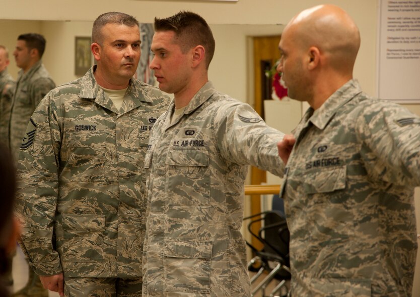 150224-F-UZ487-001: VANCE AIR FORCE BASE, Okla. – Master Sgt. James Goswick, the Airman Leadership School commandant, aligns Airmen during a formation used for inspections Feb. 24 in the Honor Guard Training room. The Airmen are members of the first ALS class at Vance.  (U.S. Air Force courtesy photo)