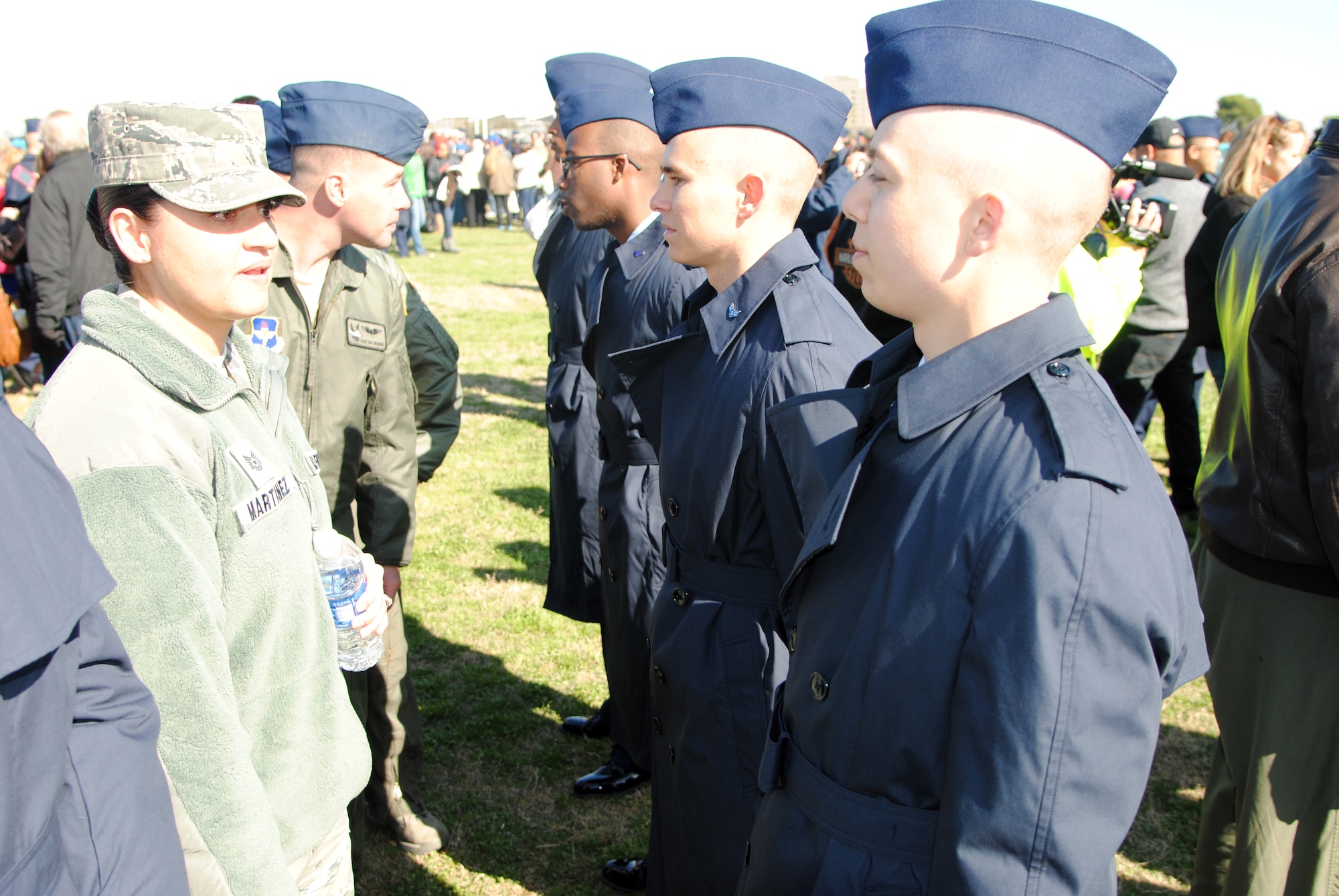 Tech Sgt. April Martinez, 58th Special Operations Wing, congratulates basic trainees, including Airman Aaron Bailey (far right), Flight 131, 323rd Basic Military Training Squadron, upon graduation Friday at Joint Base San Antonio-Lackland, Texas. Martinez was part of a group from the 58th and the 150th SOWs that visited Basic Military training to get exposure to foundational Air Force values and learn about the current state of BMT and the day-to-day life of a Military Training Instructor. (Photo by Jim Fisher)
