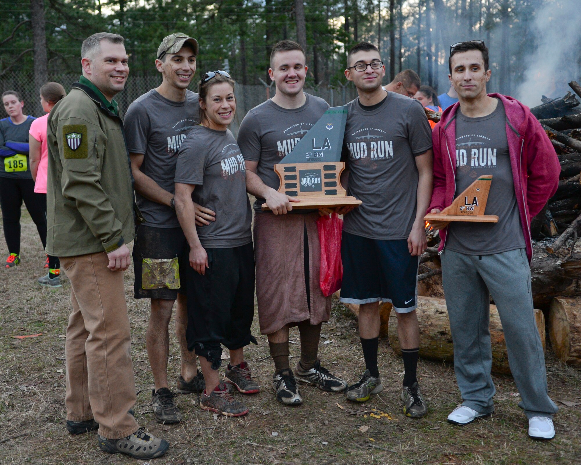 The 2nd Communications Squadron team poses for a photo with 2nd Bomb Wing Command Chief, Tommy Mazzone, after a mud run on Barksdale Air Force Base, La., March 7, 2015. The 2nd CS won the squadron wave in which teams of runners from different squadrons competed against each other. (U.S. Air Force photo/Senior Airman Benjamin Raughton)