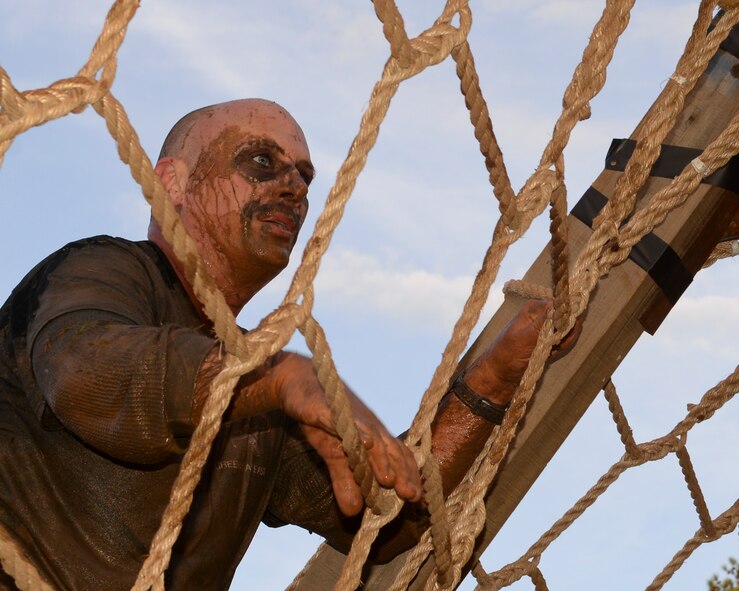 A runner climbs a rope on the final A-frame obstacle of the Defenders of Liberty Mud Run on Barksdale Air Force Base, La., March 7, 2015. The run consisted of four miles and more than 15 obstacles. (U.S. Air Force photo/Senior Airman Benjamin Raughton)