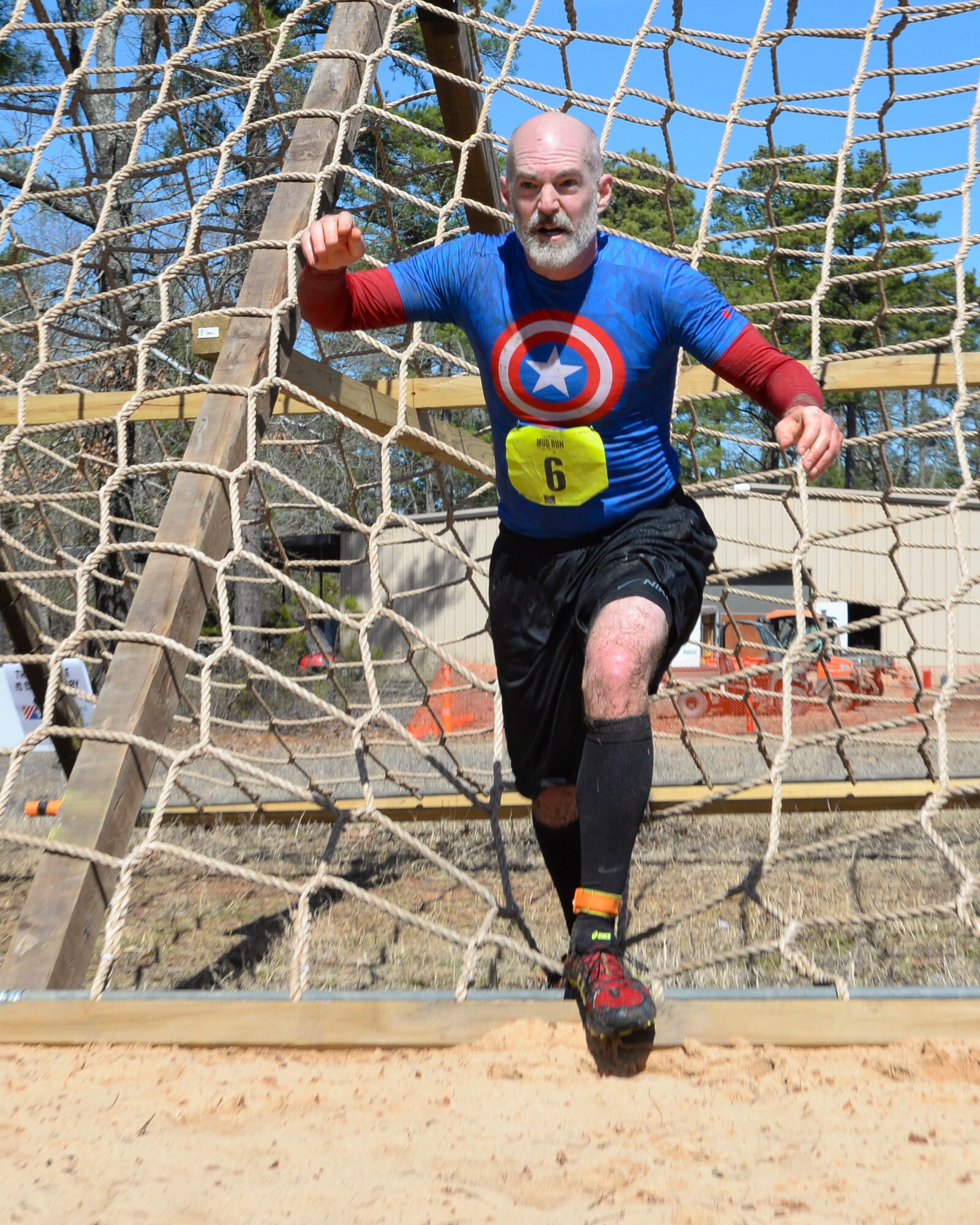 Jon Cheek makes a final sprint for the finish line during a mud run on Barksdale Air Force Base, La., March 7, 2015. After the run, participants could shower and recover with a variety of food and drinks. (U.S. Air Force photo/Senior Airman Benjamin Raughton)