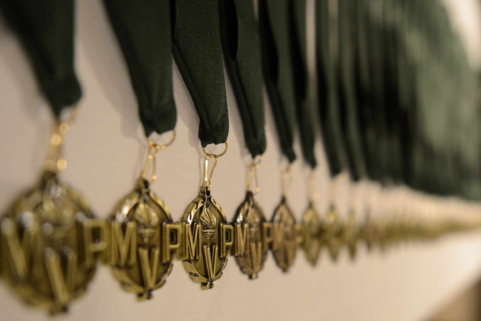 Medals representing the Team McChord Most Valuable Players lay on a table prior to the Team McChord Annual Awards banquet, March 6, 2015 at Joint Base Lewis-McChord, Wash. More than 40 members received these medals to signify them as nominees for their particular award categories for 2014. (U.S. Air Force photo/Staff Sgt. Tim Chacon)