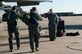 From left, 1st Lt. A.J. Brothersen, 334th Fighter Squadron student pilot, and Capt. Ryan Leavitt, 334th FS weapons systems officer instructor, salute a crew chief prior to a training flight, Dec. 10, 2014, at Seymour Johnson Air Force Base, North Carolina. Students are taught using a one-to-one instructor to student ratio during flying missions. (U.S. Air Force photo/Airman Shawna L. Keyes)  