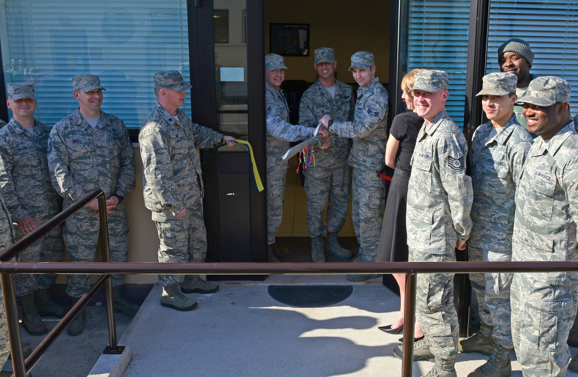 U.S. Air Force Col. Gregory Kreuder, 31st Fighter Wing vice commander, cuts the ribbon with Airmen from the 31st Civil Engineer and Communications Squadron during a grand-opening ceremony for the wing’s new Drug Demand Reduction Center, March 10, 2015, at Aviano Air Base, Italy. The DDR program helps deter the use of illegal substances to better ensure Service members are capable of supporting the mission, using randomly-selected drug tests called sweeps to help eliminate drug abuse throughout the military. (U.S. Air Force photo by Senior Airman Matthew Lotz/Released)