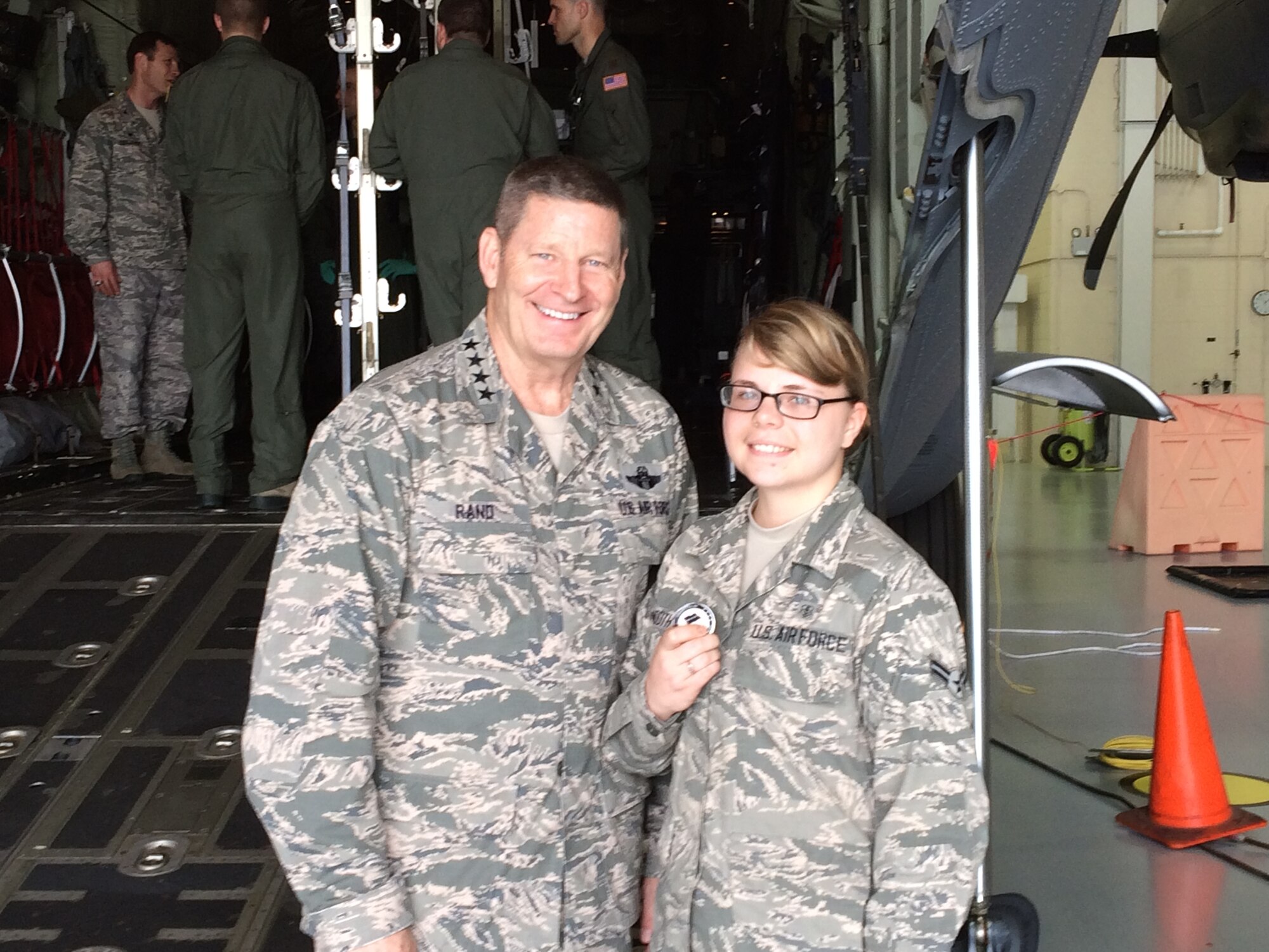 General Robin Rand, Air Education and Training Command commander, poses for a photo with Airman 1st Class Katryn Booth, 81st Aerospace Medicine Squadron public health technician, after he recognized her during the AETC Senior Leader Conference Mar. 4, 2015, inside the dual bay hangar, Keesler Air Force Base, Miss. Commanders and chief master sergeants from across AETC attended the conference which gave senior leaders an opportunity to collaborate and share ideas as they shape the future of the command.  (Courtesy photo)