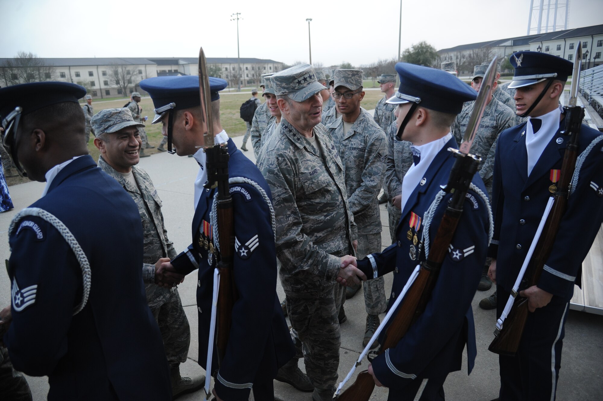 General Robin Rand, Air Education and Training Command commander, and Chief Master Sgt. Gerardo Tapia, AETC command chief, thank members of the U.S. Air Force Honor Guard Drill Team following a performance during the AETC Senior Leader Conference Mar. 4, 2015, at the Levitow Training Support Facility Drill Pad, Keesler Air Force Base, Miss. Commanders and chief master sergeants from across AETC attended the conference which gave senior leaders an opportunity to collaborate and share ideas as they shape the future of the command.  (U.S. Air Force photo by Kemberly Groue)