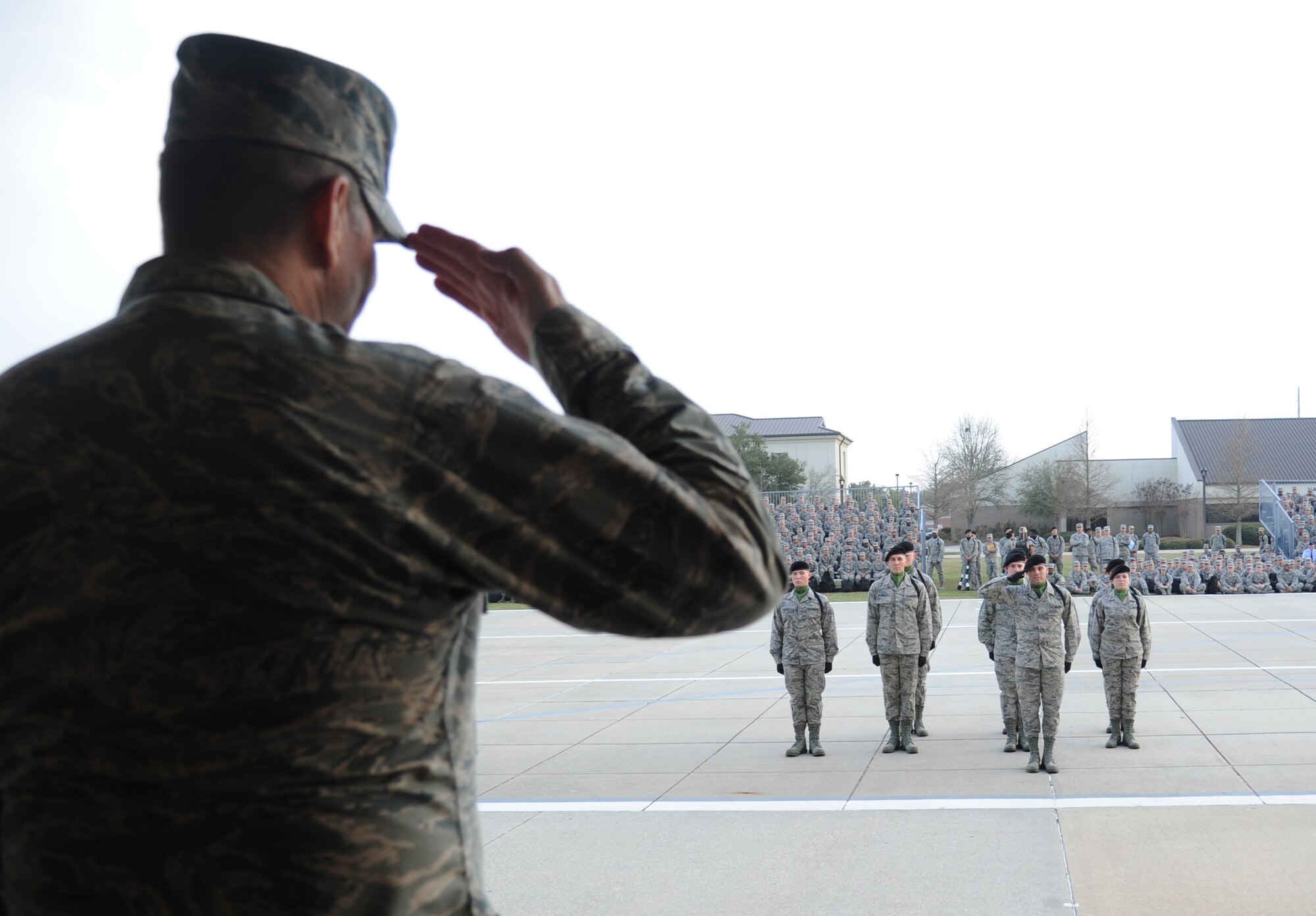 General Robin Rand, Air Education and Training Command commander, returns a salute to the 334th Training Squadron freestyle drill master during the 81st Training Group drill down performance during the AETC Senior Leader Conference Mar. 4, 2015, at the Levitow Training Support Facility Drill Pad, Keesler Air Force Base, Miss. Commanders and chief master sergeants from across AETC attended the conference which gave senior leaders an opportunity to collaborate and share ideas as they shape the future of the command.  (U.S. Air Force photo by Kemberly Groue)