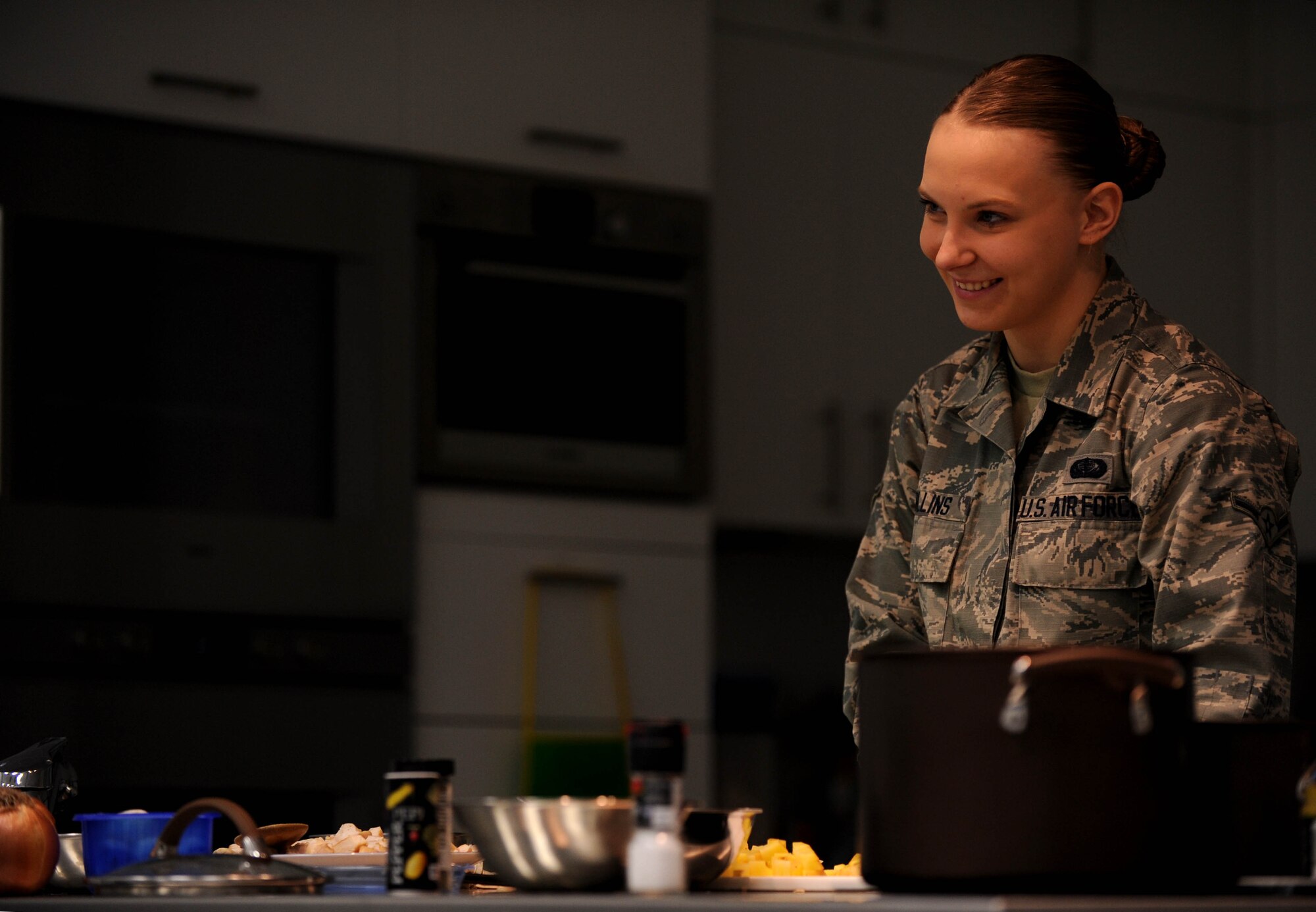 U.S. Air Force Airman Kimberly Collins, 52nd Force Support Squadron fitness apprentice, answers questions from the audience during a cooking demonstration at the Health Promotions Kitchen in the Eifel Powerhaus at Spangdahlem Air Base, Germany, Feb. 11, 2015. Collins cooked for a demonstration event as part of the Largest Loser Campaign, a collaborative effort of the Health Promotion’s office and the fitness center designed to aid individuals seeking a healthier lifestyle. The demonstration included a chicken-pot-pie soup and whole-wheat buttermilk cheese biscuits as healthier substitutions to an actual chicken-pot-pie and its crust. (U.S. Air Force photo by Airman 1st Class Timothy Kim/Released)