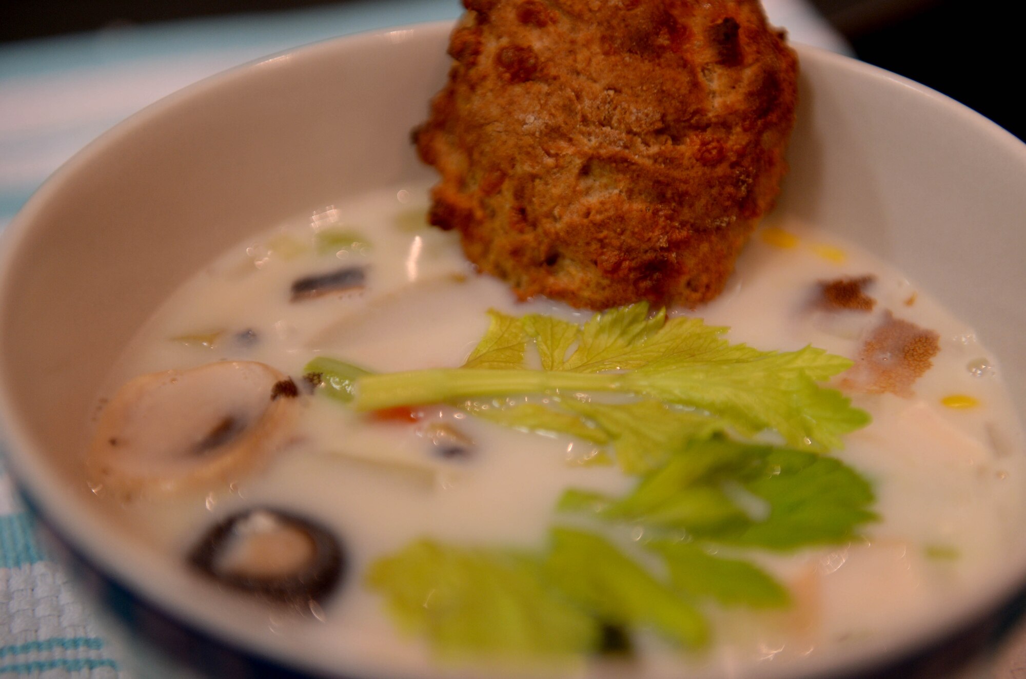 A chicken-pot-pie soup is displayed with a whole-wheat buttermilk cheese biscuit during a cooking demonstration at the Health Promotions Kitchen in the Eifel Powerhaus at Spangdahlem Air Base, Germany, Feb. 11, 2015. U.S. Air Force Airman Kimberly Collins, 52nd Force Support Squadron fitness apprentice, prepared the soup for the demonstration as part of the Largest Loser Campaign, a collaborative effort of the Health Promotion’s office and the fitness center designed to aid individuals seeking a healthier lifestyle. The ingredients for the soup included flour, water, fat-free milk, celery stalks, chopped onions, baby portabella mushrooms, chicken bouillon, ground pepper, thyme, mixed vegetables, potatoes, salt and diced chicken breasts. (U.S. Air Force photo by Airman 1st Class Timothy Kim/Released)