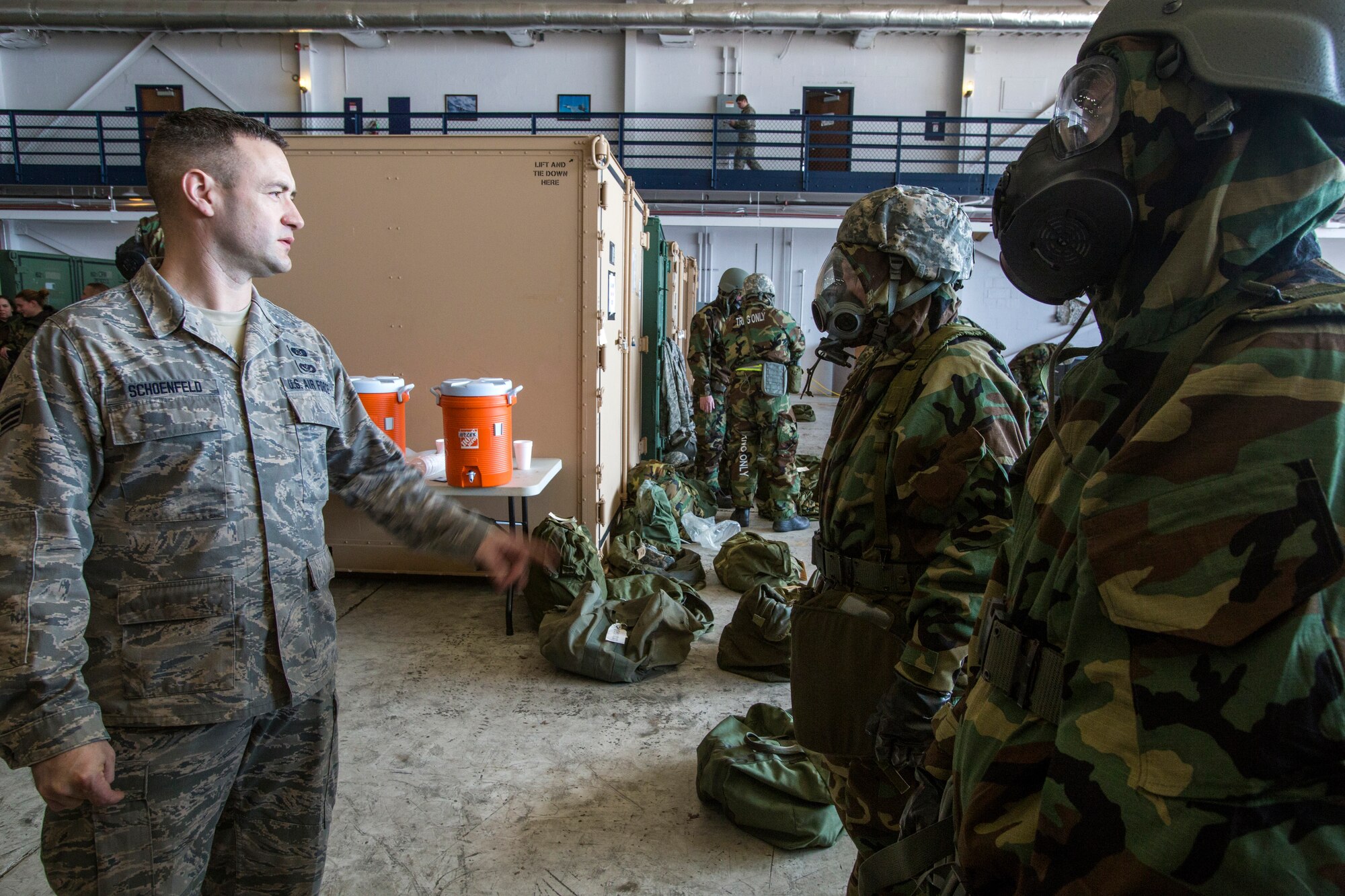 Senior Airman Seth L. Schoenfeld, left, Readiness and Emergency Management Flight, 108th Civil Engineer Squadron, 108th Wing, checks to see if Airmen have properly donned their M50 joint service general purpose masks and mission-oriented protective posture gear during the Wing’s Expeditionary Skills Rodeo at Joint Base McGuire-Dix-Lakehurst, N.J., March 7, 2015. In addition, they trained on their ability to survive and operate in a chemical, biological, radiological and nuclear environment. These skills make up the foundation necessary for all Airmen to function effectively in hostile environments. (U.S. Air National Guard photo by Master Sgt. Mark C. Olsen/Released)