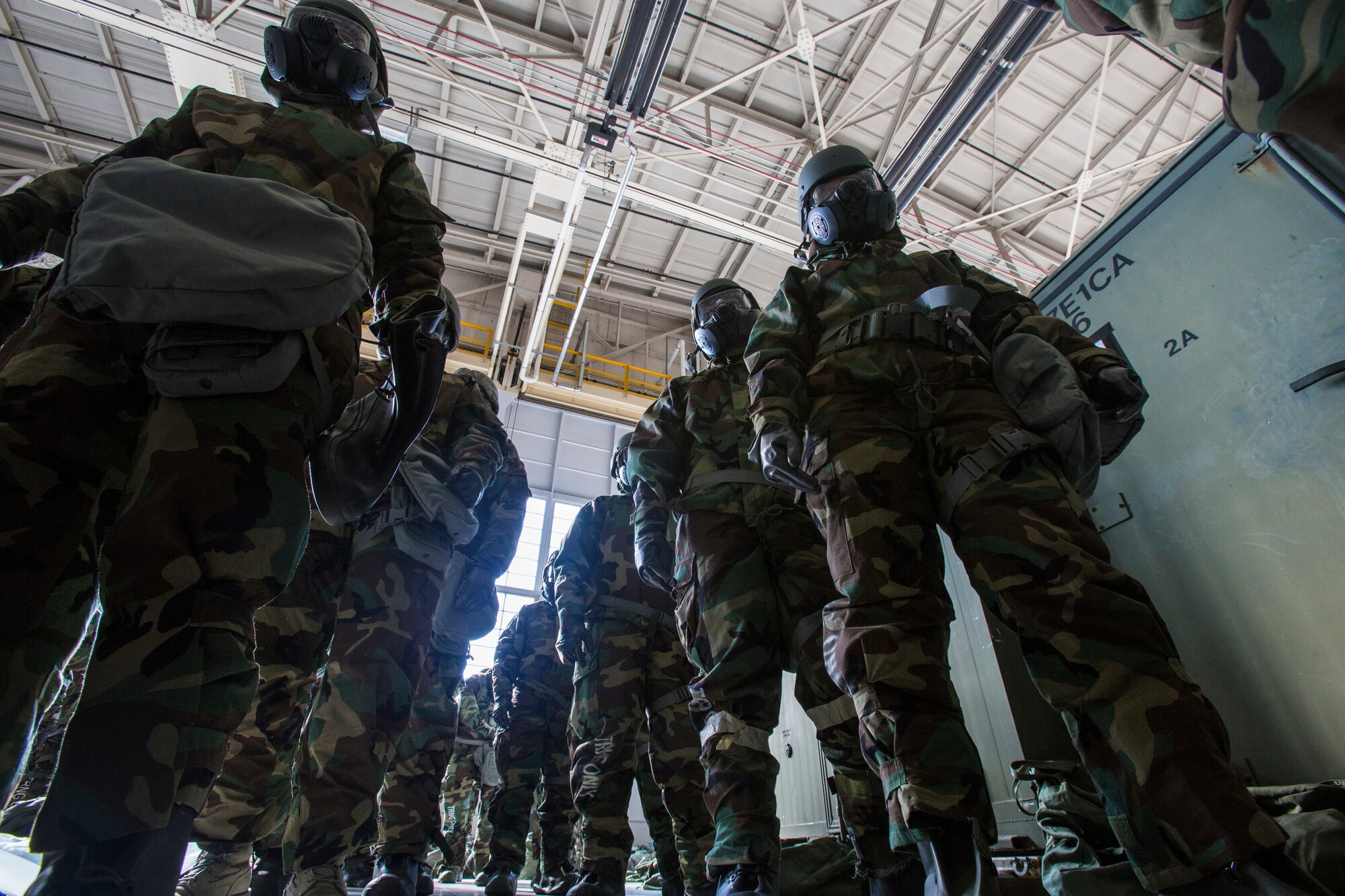 Airmen from the 108th Wing wait in line wearing their mission-oriented protective posture gear during the Wing’s Expeditionary Skills Rodeo at Joint Base McGuire-Dix-Lakehurst, N.J., March 7, 2015. In addition, they trained on their ability to survive and operate in a chemical, biological, radiological and nuclear environment. These skills make up the foundation necessary for all Airmen to function effectively in hostile environments. (U.S. Air National Guard photo by Master Sgt. Mark C. Olsen/Released)
