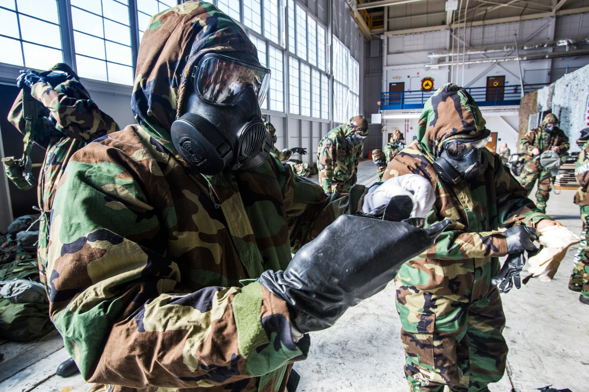 Airmen from the 108th Wing don mission-oriented protective posture gear during the Wing’s Expeditionary Skills Rodeo at Joint Base McGuire-Dix-Lakehurst, N.J., March 7, 2015. In addition, they trained on their ability to survive and operate in a chemical, biological, radiological and nuclear environment. These skills make up the foundation necessary for all Airmen to function effectively in hostile environments. (U.S. Air National Guard photo by Master Sgt. Mark C. Olsen/Released)