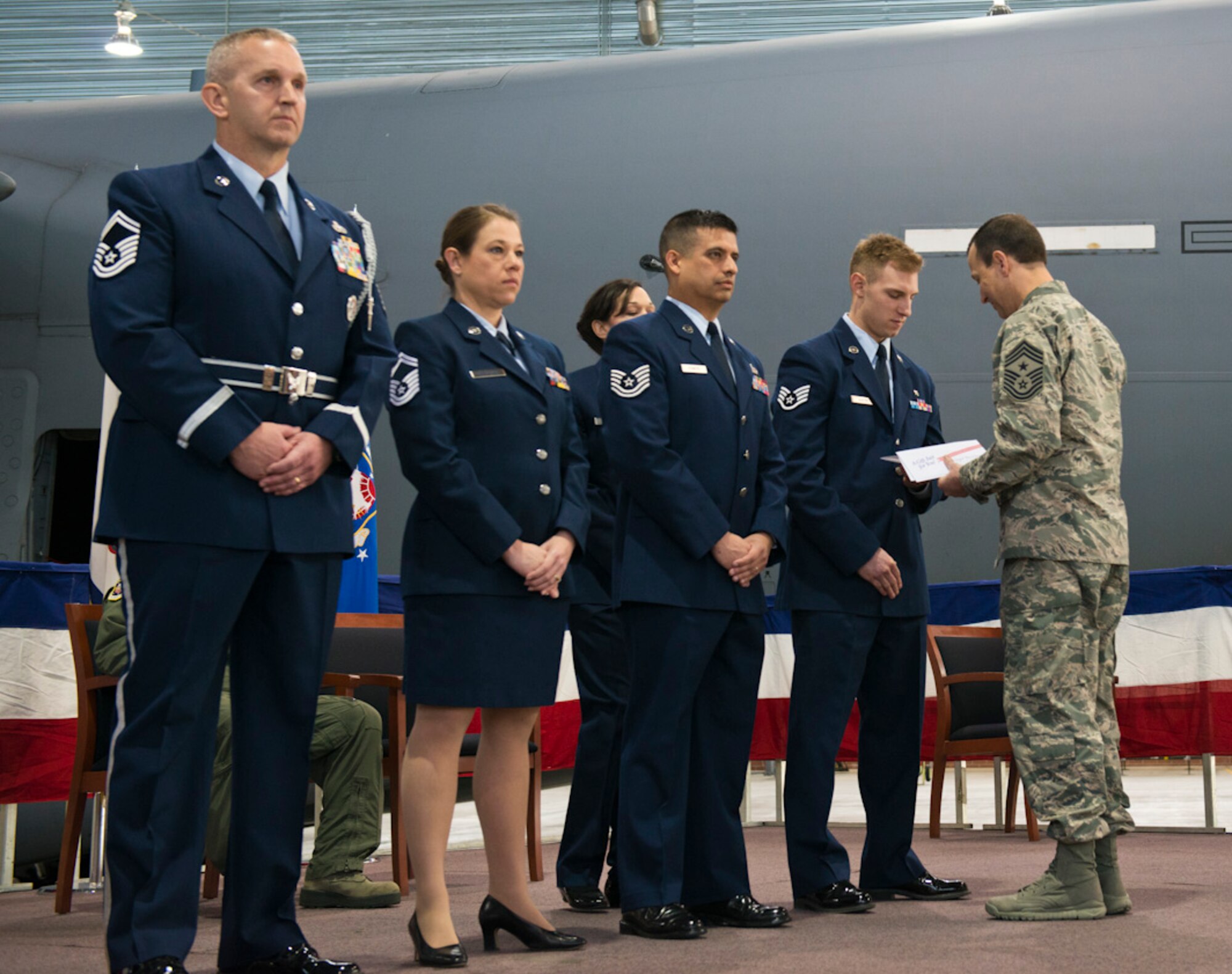 Chief Master Sgt. Ron R. Glazer, Sr. 167th Airlift Wing command chief, right, presents awards to Staff Sgt. Brock Martin,the wing's Outstanding Airman of the Year for the Airman category during a ceremony at the Martinsburg, W.Va., air base, Mar 8. Senior Master Sgt. Todd Kirkwood, left, Senior Master Sgt. Chanda Keesecker and Tech Sgt Alan Romero were also recognized as Outstanding Airmen of the Year for the wing. (Air National Guard photo by Staff Sgt. Jodie Witmer)
