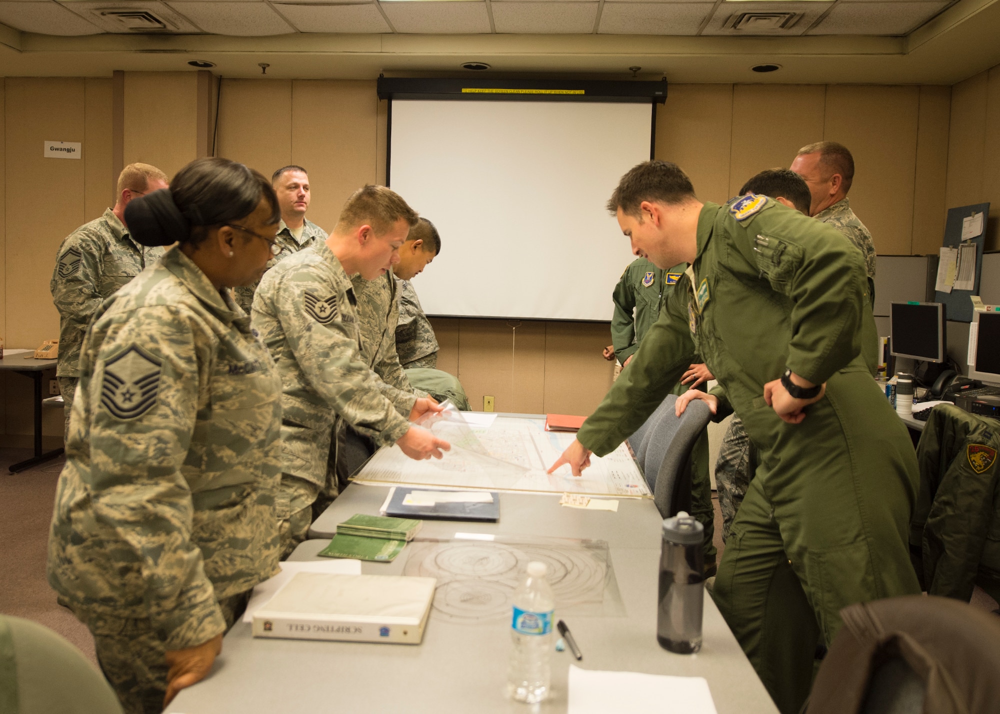 Wing Operation Center staff produce a scenario March 9, 2015, to interject into exercise Key Resolve at the Republic of Korea Air Force Simulation Center at Osan Air Base, Republic of Korea. The exercise is mostly computer based, offering participants the opportunity to respond to varying scenarios to produce close to real-life responses. (U.S. Air Force photo by Staff Sgt. Shawn Nickel/Released)