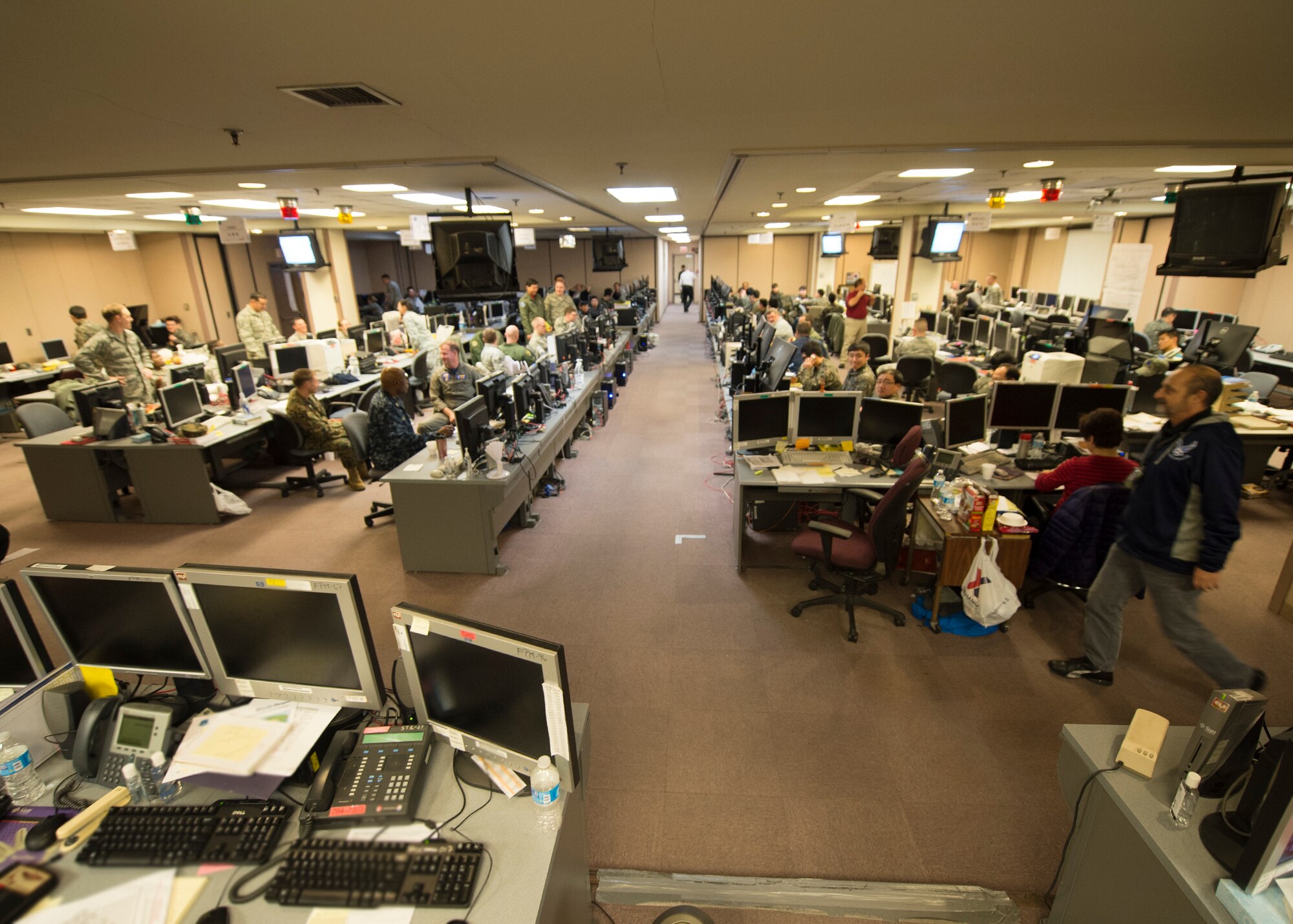 U.S. service members work alongside Republic of Korea (ROK) military counterparts March 9, 2015, to produce scenarios for exercise Key Resolve 2015 in the ROK Air Force Simulation Center at Osan Air Base, Republic of Korea. Key Resolve is an annual combined and joint command post exercise that employs U.S. military personnel from bases around the Republic of Korea (ROK) and the United States, as well as ROK air force. The exercise is mostly computer based. (U.S. Air Force photo by Staff Sgt. Shawn Nickel/Released)