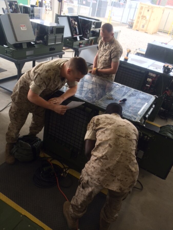 Marines troubleshoot equipment.