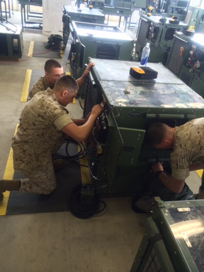 Marines troubleshoot equipment.