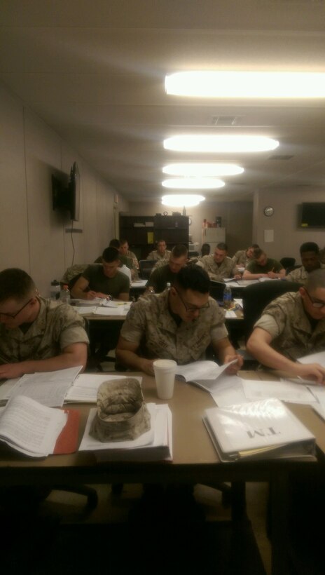 Marines work on technical manuals.