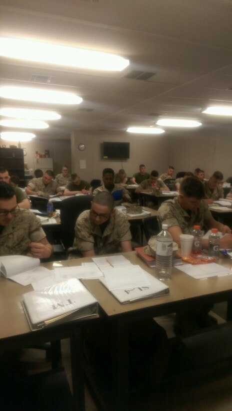 Marines work on maintenance forms.