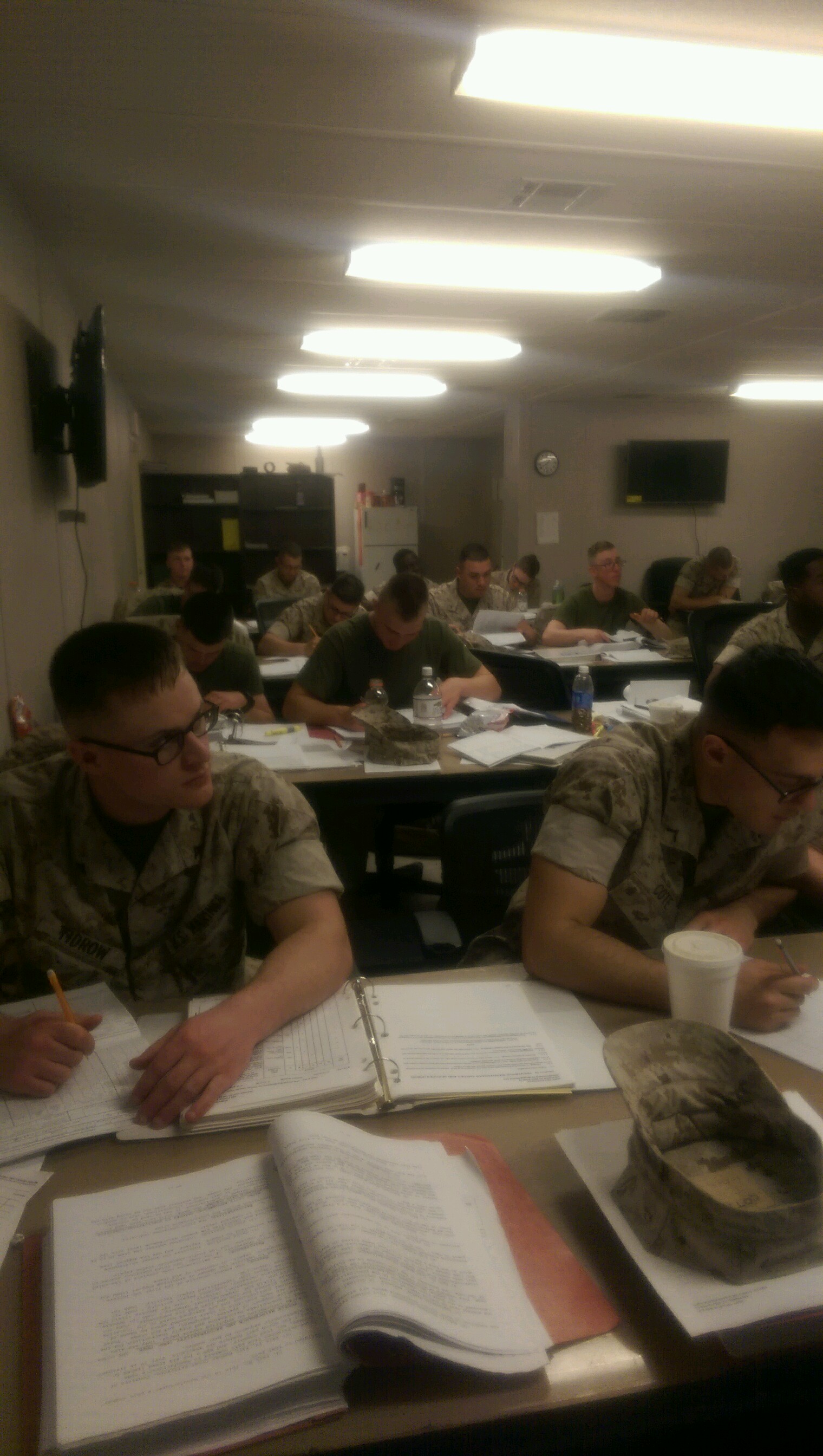 Marines work on technical manuals.