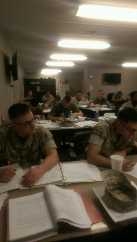 Marines work on technical manuals.