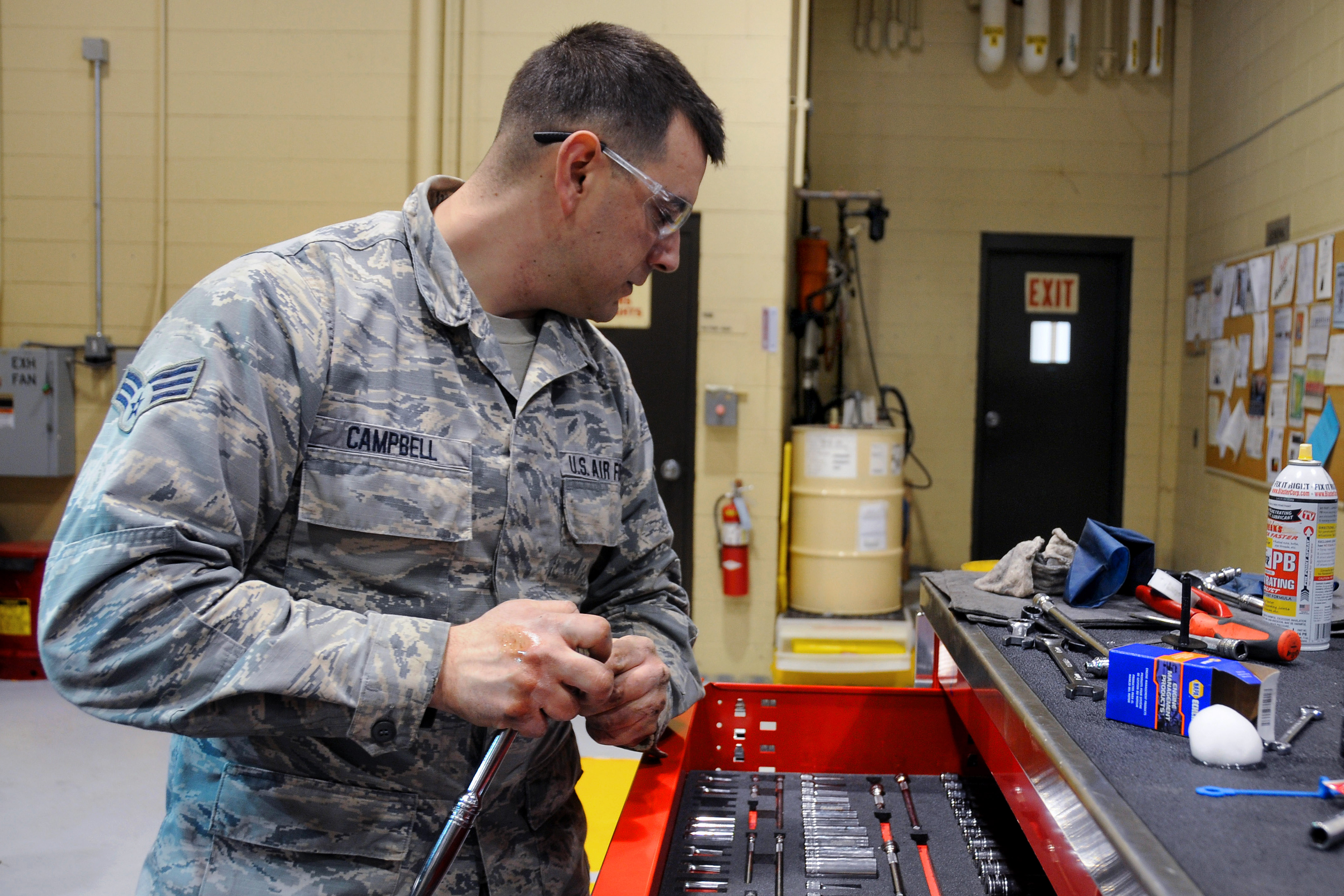 Air Force Senior Airman Jeff Campbell grabs a socket while performing