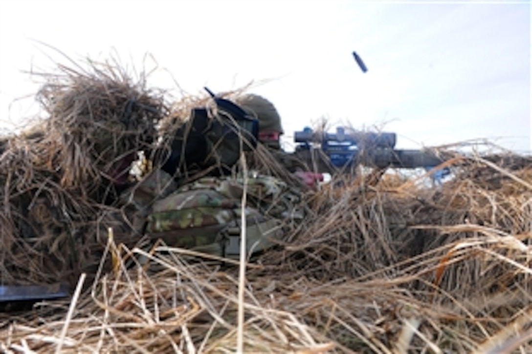 A U.S. Army sniper shoots at targets while another soldier observes by looking through a magnification device during an exercise at Adazi Training Area, Latvia, March 6, 2015. The Americans are associated with Operation Atlantic Resolve and are training with Europeans. The soldiers are assigned to Mortar Platoon, Headquarters Troop, 2nd Cavalry Regiment, and are regularly stationed in Germany.