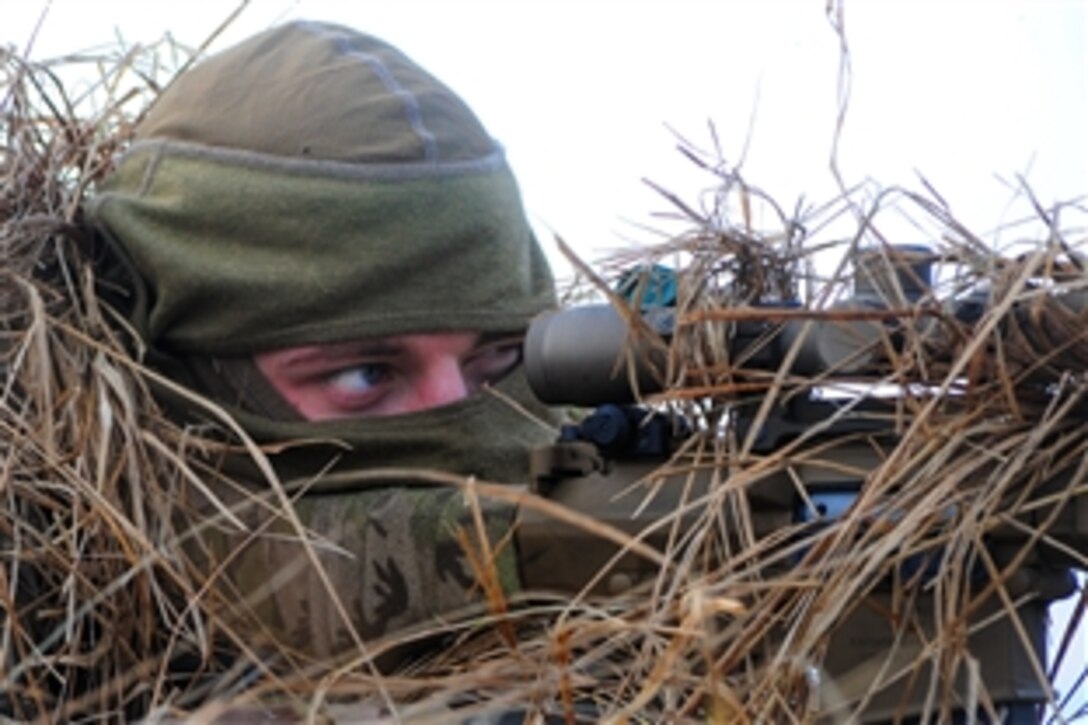 A U.S. Army sniper engages simulated enemy targets during a combined live-fire exercise as part of Operation Atlantic Resolve in the Adazi training area in Latvia, March 6, 2015. The soldier is assigned to Mortar Platoon, Headquarters Troop, 2nd Cavalry Regiment.