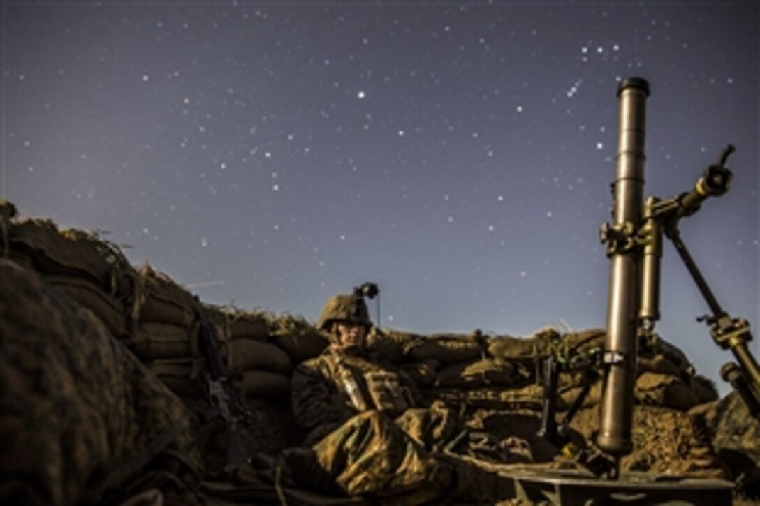 U.S. Marine Lance Cpl. Griffin Forrester stands watch from a fighting hole during amphibious squadron and Marine expeditionary unit integration training in Camp Pendleton, Calif., March 6, 2015.