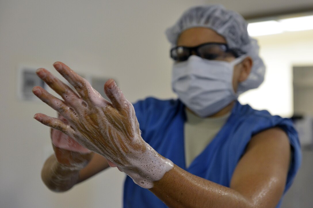 Senior Airman Sylvia Coon scrubs her hands before assisting with a surgery March 4, 2015, at Aviano Air Base, Italy. Surgical technicians are enlisted Service members responsible for supporting the surgeon and sterilizing and maintaining medical instruments. Coon is a 31st Surgical Operations Squadron surgical technician. (U.S. Air Force photo/Airman 1st Class Ryan Conroy)
