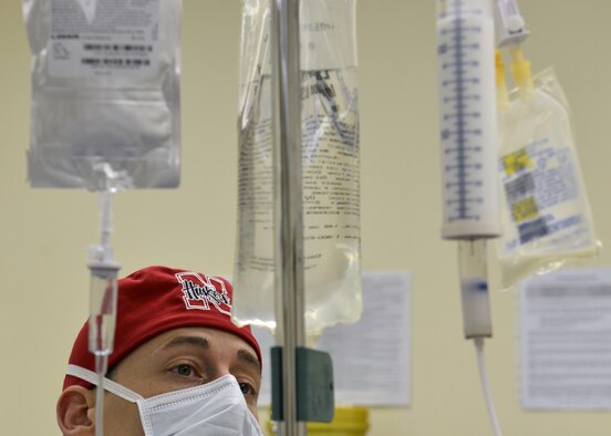 Capt. Sean Bancroft observes a patient’s intravenous drip during a surgery March 4, 2015, at Aviano Air Base, Italy. Bancroft is a 31st Surgical Operations Squadron certified registered nurse anesthetist (CRNA). A CRNA is responsible for administering anesthetic agents to patients and monitoring their reactions to the anesthesia and surgery. (U.S. Air Force photo/Airman 1st Class Ryan Conroy)