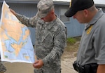 Sgt. 1st Class Chuck Morrow (left) of the Florida Army National Guard reviews Gulf Coast beach locations with Capt. Paul Arkin of the Florida Department of Environmental Protection at St. Andrews State Park just east of Panama City Beach on Florida’s Panhandle, June 21, 2010. National Guard Soldiers were hitting Florida’s beaches as part of the ongoing response to the Deepwater Horizon oil spill in the Gulf of Mexico.