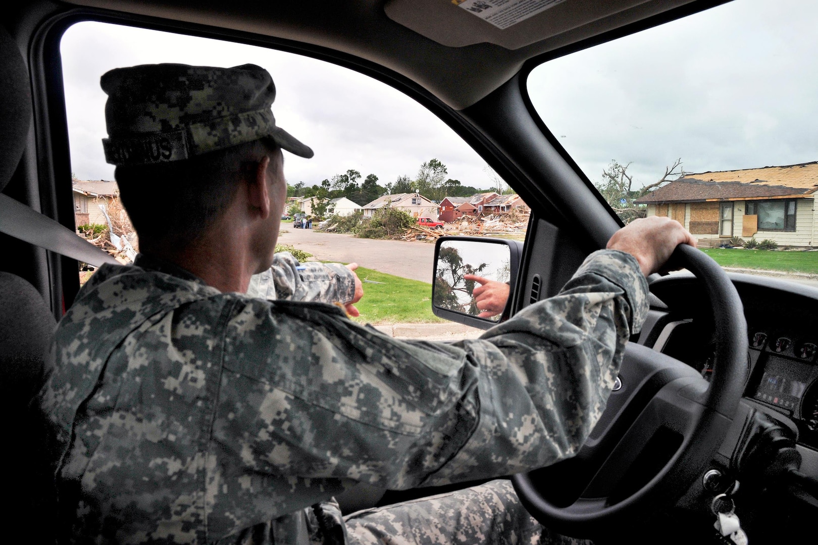 Army Sgt. 1st Class Dusty Greydanus points out some of the damaged homes following a deadly tornado in as he conducts a roaming patrol in Wadena, Minn., June 19, 2010. Greydanus is assigned to Company D, 2nd Battalion, 136 Combined Arms Battalion of the Minnesota National Guard. Severe storms have ravaged several northern states this week, including Montana, Minnesota and Wisconsin.