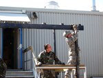 Guardsmen from the 139th Civil Engineering Squadron construct a canopy over a billeting facility at a Canadian Forward Operating Base (FOB) in support of the Engineering Exchange program in June