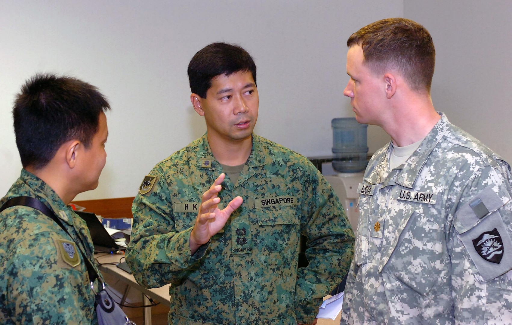 Lt. Col. Johnny Lee, deputy of operations for 9th Singapore Division (Infantry), discusses details of Tiger Balm with his U.S. counterpart, Maj. Joe Lontai, assistant operations officer for the 82nd Support Detachment of the Oregon Army National Guard June 13, 2010. Tiger Balm is an annual coalition training exercise between the Singapore Army and U.S. National Guard and Reserve Soldiers and Airmen.