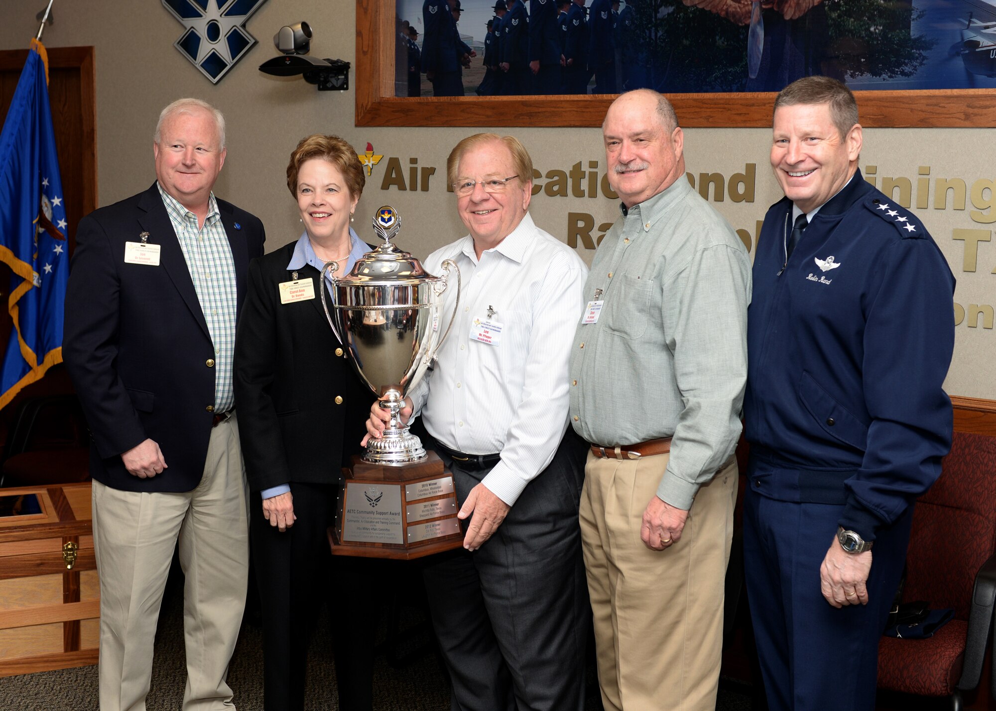 Gen. Robin Rand, commander of Air Education and Training Command, poses for a photo with Dr. Joe Leverett (left), Medical Director, Integris Family Care Clinic, and Goodfellow Air Force Base civic leaders, Dr. Carol Ann Bonds, Mr. Lee Pfluger and Mr. Chase Holland during the presentation of the Altus Trophy at Joint Base San Antonio-Randolph, Texas, March 11, 2015. The Altus Trophy, also known as the Air Education and Training Command Community Support Award, is presented by the Altus, Oklahoma, Chamber of Commerce each year to the community that has shown the most outstanding support to an AETC unit. (U.S. Air Force photo by Tech. Sgt. Joshua Strang)
