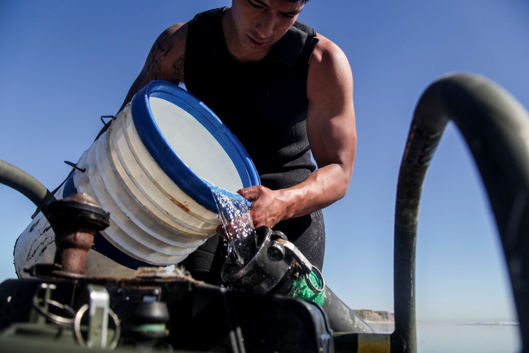 U.S. Marine Lance Cpl. Fransisco pours ocean water into a water purification pipe aboard Camp Pendleton, Calif., March 6, 2015. Hernandez is a water purification specialist with Combat Logistics Battalion 15, 15th Marine Expeditionary Unit. The Marines made drinking water by running ocean water through a tactical water purification system during Amphibious Squadron/Expeditionary Unit Integration Training (PMINT).   (U.S. Marine Corps photo by Cpl. Elize McKelvey/Released)
