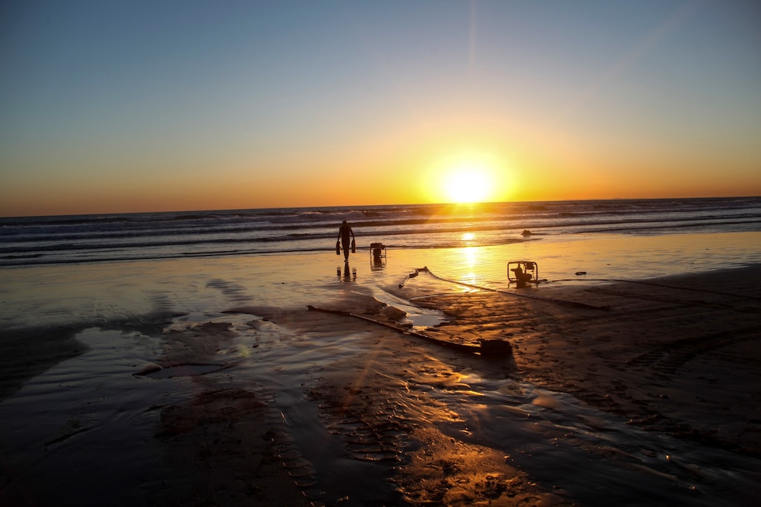 A U.S. Marine with the Combat Logistics Battalion 15, 15th Marine Expeditionary Unit, cleans up a training area aboard Camp Pendleton, Calif., March 6, 2015. The Marines  made drinking water by running ocean water through a tactical water purification system during Amphibious Squadron/Expeditionary Unit Integration Training (PMINT).  (U.S. Marine Corps photo by Cpl. Elize McKelvey/Released)