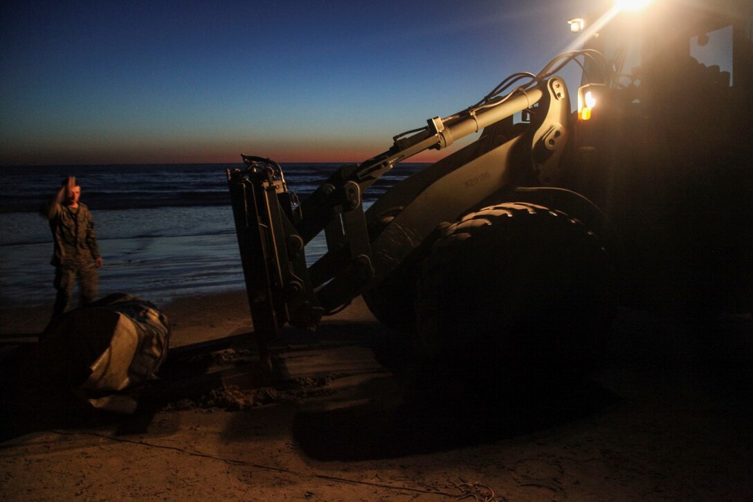 A U.S. Marine with the Combat Logistics Battalion 15, 15th Marine Expeditionary Unit, uses a tractor, rubber-tired, articulated steering, multi-purpose (TRAM) vehicle to clean up a training area aboard Camp Pendleton, Calif., March 6, 2015. The Marines  made drinking water by running ocean water through a tactical water purification system during Amphibious Squadron/Expeditionary Unit Integration Training (PMINT).    (U.S. Marine Corps photo by Cpl. Elize McKelvey/Released)