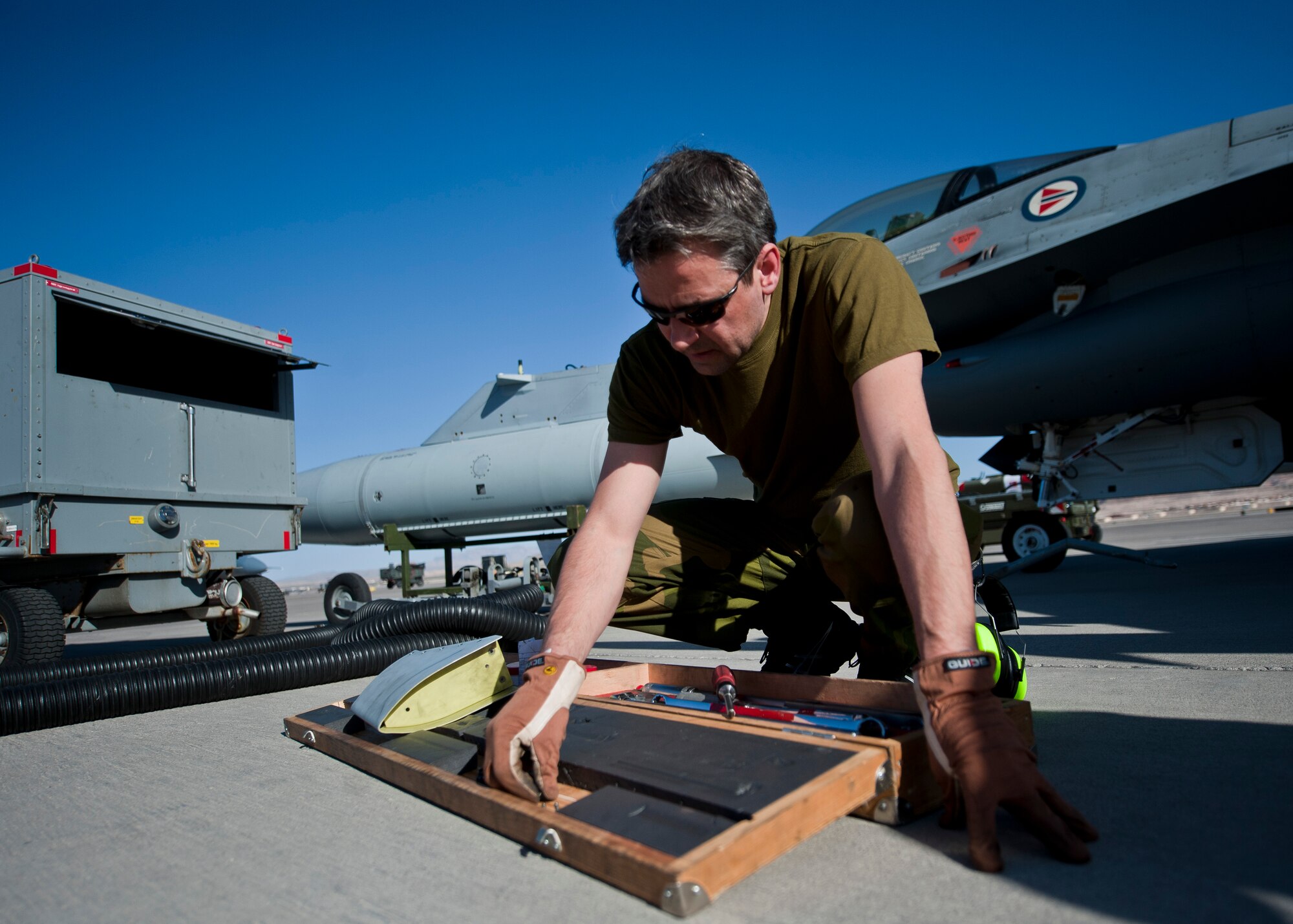 Royal Norwegian Air Force Capt. Per-A Hoftun, 338th Squadron maintainer, looks for a tool during Red Flag 15-2 at Nellis Air Force Base, Nev., March 6, 2015. Red Flag exercises provide a series of intense scenarios for aircrew and ground personnel to increase their combat readiness and effectiveness for future real-world missions. (U.S. Air Force photo by Staff Sgt. Siuta B. Ika)