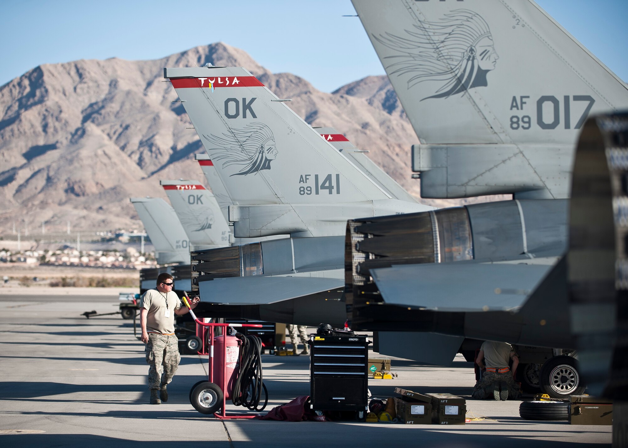 A maintainer assigned to the 125th Aircraft Maintenance Squadron, Tulsa Air National Guard Base, Okla., walks through a row of F-16 Fighting Falcons during Red Flag 15-2 at Nellis Air Force Base, Nev., March 6, 2015. Red Flag provides realistic combat training in a contested, degraded and operationally-limited environment, which provides aircrews with real-time war scenarios and helps ground crews test and improve their operational readiness. (U.S. Air Force photo by Staff Sgt. Siuta B. Ika)