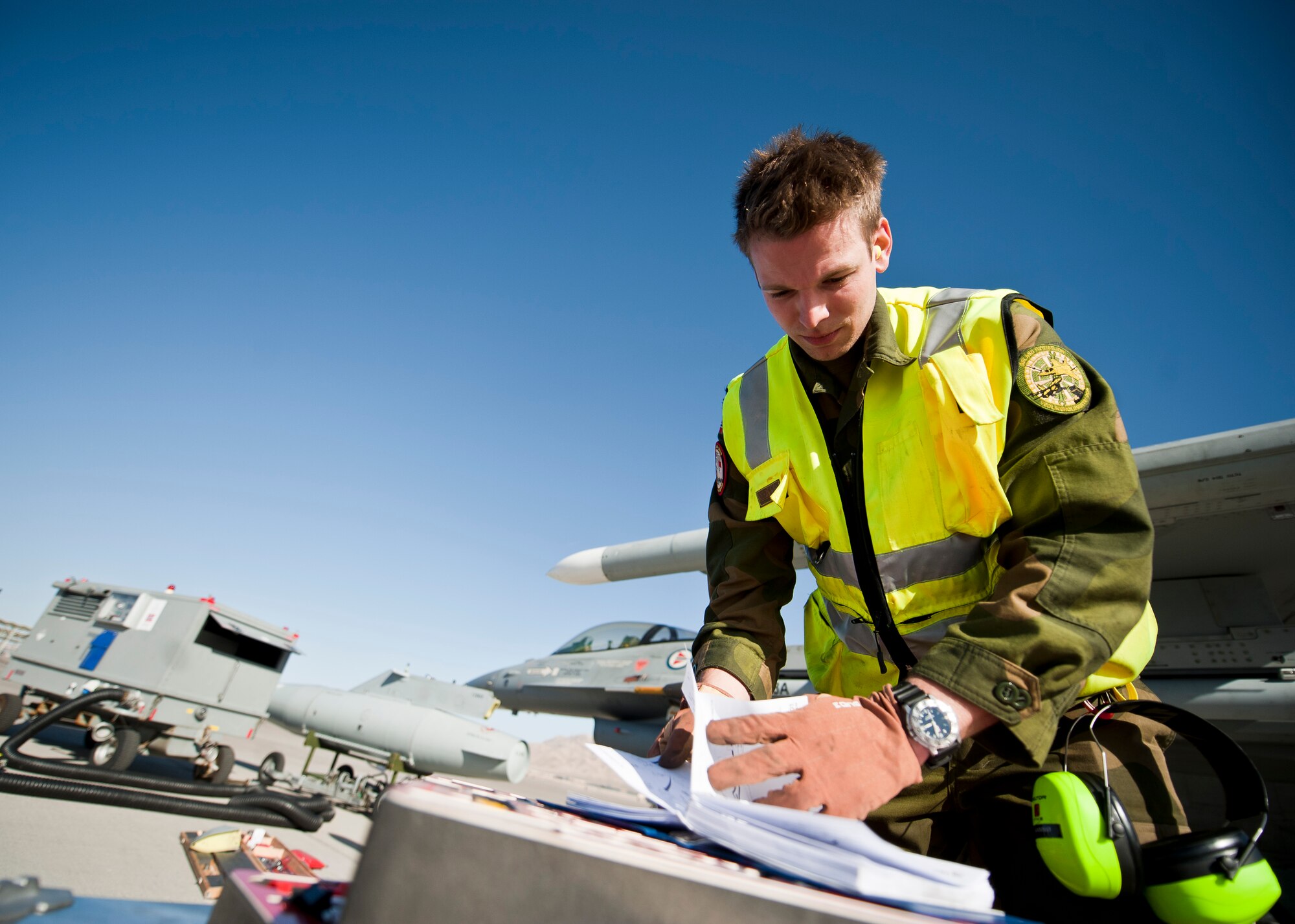 Royal Norwegian Air Force 2nd Lt. Erlemd Aannoe, 338th Squadron maintainer, looks over a technical order during Red Flag 15-2 at Nellis Air Force Base, Nev., March 6, 2015. Flying units from around the world come to Nellis AFB to participate in Red Flag exercises, which are held three to four times per year. (U.S. Air Force photo by Staff Sgt. Siuta B. Ika)