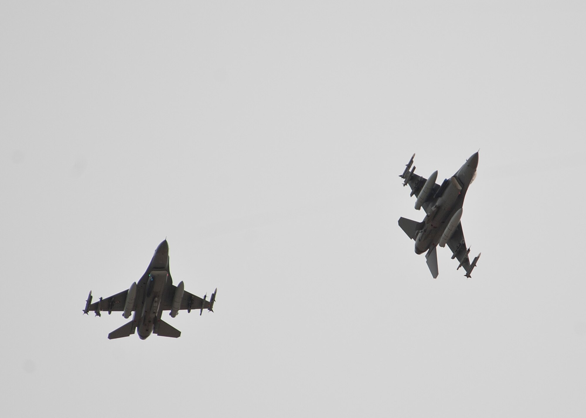 Two Royal Norwegian Air Force F-16 Fighting Falcons pitch out in preparation to land after a Red Flag 15-2 sortie at Nellis Air Force Base, Nev., March 11, 2015. Red Flag is a realistic combat training exercise involving air, space and cyber forces of the U.S. and its allies. (U.S. Air Force photo by Staff Sgt. Siuta B. Ika)